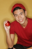 Young man holding a ball, yellow background - Alex Microstock02