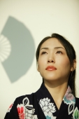 Young woman wearing a kimono, looking up. - Alex Microstock02