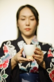 Young woman in kimono holding a tea cup - Alex Microstock02