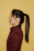 Young woman, side view, yellow background - Alex Microstock02