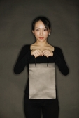 Young woman carrying shopping bag, black background - Alex Microstock02
