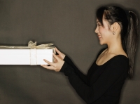 Young woman holding a gift, black background - Alex Microstock02