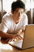 Young man using laptop. - Alex Microstock02