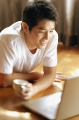 Young man looking at laptop, - Alex Microstock02