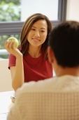 Couple facing each other, woman holding an apple - Alex Microstock02