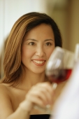 Woman raising wine glass, toasting - Alex Microstock02