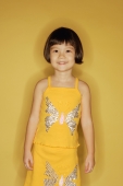 Young girl standing in front of yellow wall - Alex Microstock02