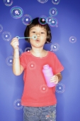 Young girl blowing bubbles from bubble wand - Alex Microstock02