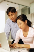 Young couple using laptop at home - Alex Microstock02