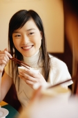 Young women at a Chinese restaurant, eating - Alex Microstock02