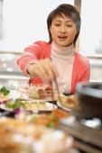 Young woman at a Chinese restaurant, eating - Alex Microstock02