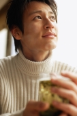 Young man holding teacup, looking away - Alex Microstock02