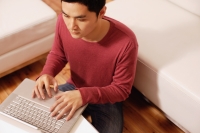 Young man using laptop, high angle view - Alex Microstock02