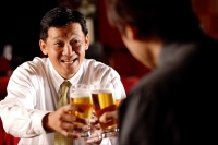 Two men toasting with beer glasses. - Alex Microstock02