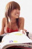 Young woman with magazine, smiling - Alex Microstock02