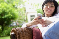 Woman using mobile phone, text messaging, smiling - Alex Microstock02