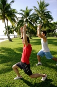  Men doing stretching exercises in park, arms raised upward - Alex Microstock02