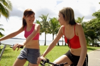 Two women on bicycles, side by side - Alex Microstock02