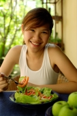 Woman eating salad, looking at camera - Alex Microstock02