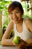 Woman holding an apple, looking at camera - Alex Microstock02
