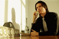 Executive sitting at desk, on the phone - Alex Microstock02