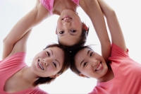 Young women, arms around each other, looking down - Alex Microstock02