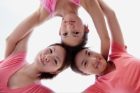  Young women, arms around each other, looking down at camera - Alex Microstock02