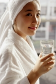  Young woman in robe holding glass of water - Alex Microstock02