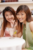  Two young women, looking at camera, drinking milkshakes - Alex Microstock02