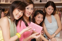 Young women looking at camera, holding wallet - Alex Microstock02