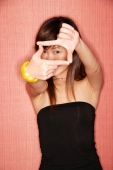 Young woman in tube top making hand sign, looking at camera - Alex Microstock02