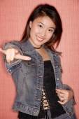 Young woman wearing denim jacket making hand gesture - Alex Microstock02