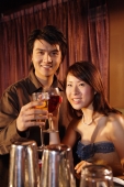 Couple holding drinks looking at camera - Alex Microstock02