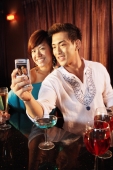 Couple using camera phone, posing for picture - Alex Microstock02