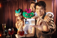 Couples with masks taking a picture with camera - Alex Microstock02