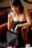 Young woman drinking from cup, looking away - Alex Microstock02