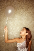 Young woman holding balloon, looking up - Alex Microstock02