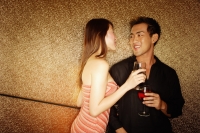 Couple standing with wine glass, face to face - Alex Microstock02
