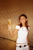 Young woman holding champagne glass, looking at camera - Alex Microstock02