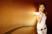 Young woman using mobile phone, smiling - Alex Microstock02