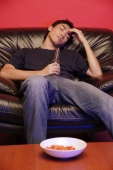 Young man on soda, holding beer bottle, eyes closed - Alex Microstock02