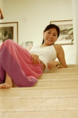Woman sitting on stairs, looking down - Alex Microstock02