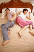 Couple lying in bed, back to back - Alex Microstock02