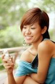 Young woman smiling, looking at mobile phone - Alex Microstock02