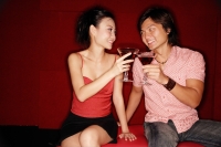 Couple toasting with drinks, looking at each other - Alex Microstock02