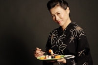 Woman in Japanese costume, holding chopsticks and a plate of Japanese food - Alex Microstock02