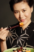 Woman in Japanese costume, eating sushi, portrait - Alex Microstock02
