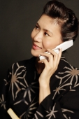 Woman in Japanese costume, using mobile phone, looking away - Alex Microstock02