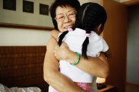 Grandmother hugging granddaughter - Jade Lee