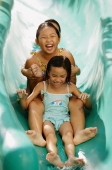 Three girls going down water slide - Jade Lee
